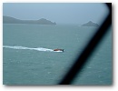The Padstow Lifeboat patrols Port Quin Bay as viewed from Doyden Castle